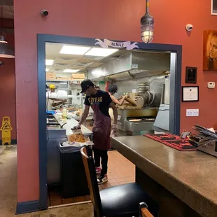 a woman preparing food in the kitchen