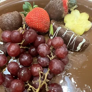 a plate of chocolate covered fruit