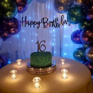 a table with candles and balloons