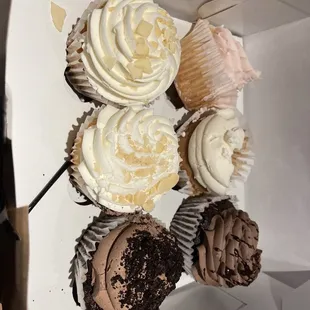 a box of cupcakes with frosting