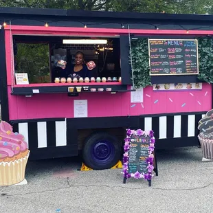a pink and black food truck