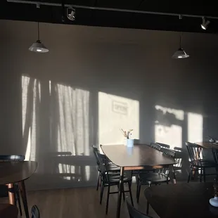 a long table with chairs and a vase of flowers