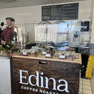 a man standing behind the counter