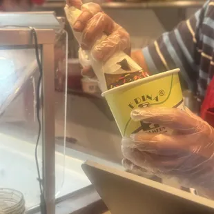 The waffle cone got overfilled so he put it in a cup