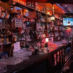 a bar with a lot of bottles and glasses