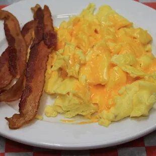 bacon and scrambled eggs on a plate