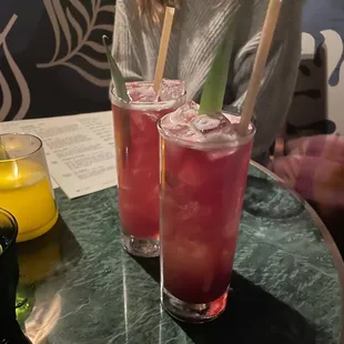 a woman sitting at a table with drinks