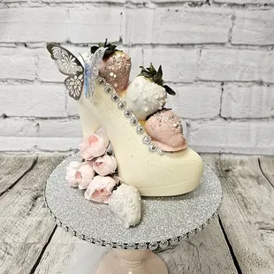 a cake with a shoe and flowers