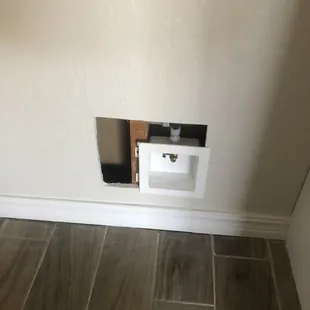 Hole in wall after water line was put in.