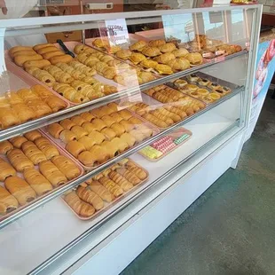 a display case with a variety of donuts