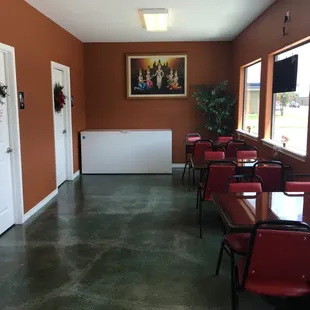 a row of red chairs in a restaurant