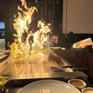 a man cooking food on a grill