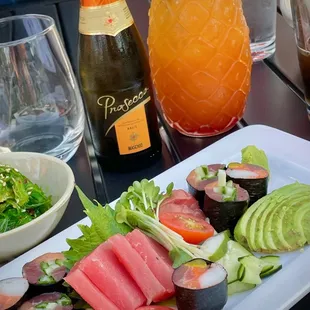 Small sashimi platter with rice-less rolls and avocado.