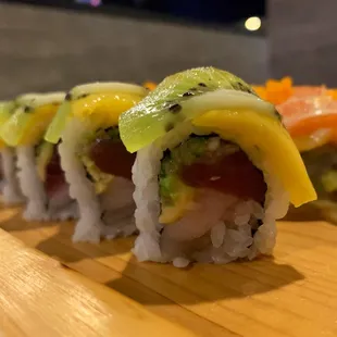 Kiwi Mango - tuna, hamachi, avocado, cucumber, topped with mango, kiwi, and kiwi sauce