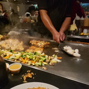 a person cooking food on a grill