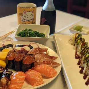 a plate of sushi and a bottle of wine