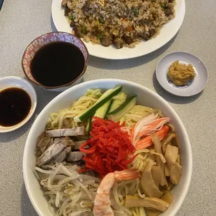 a bowl of noodles, shrimp, and vegetables