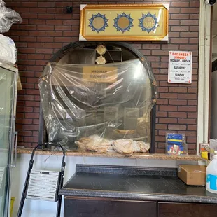 a brick oven in the middle of a kitchen
