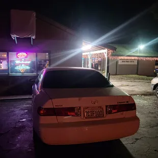 a car parked in front of a restaurant