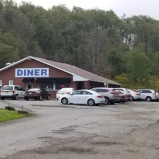 cars parked in front of a diner