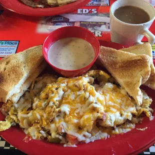 Famous Garbage Omelet. Potatoes, Sausage, Bacon, Scrambled Eggs, Cheese, Peppers, Onions, Tomatoes, Toast and Gravy.