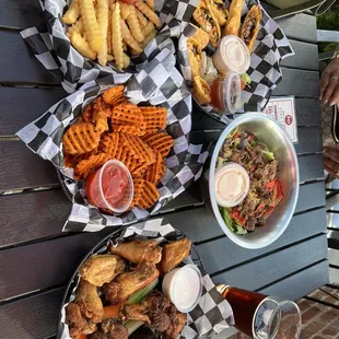 a variety of food on a picnic table