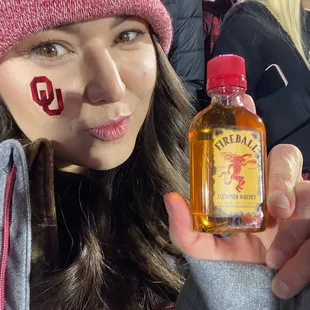 a woman holding a bottle of whiskey