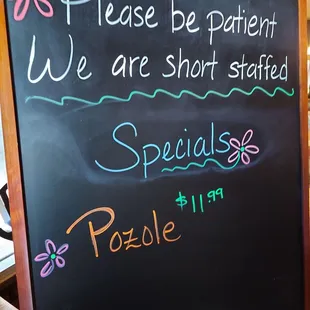a blackboard with a sign that says please be patient we are short - stuffed