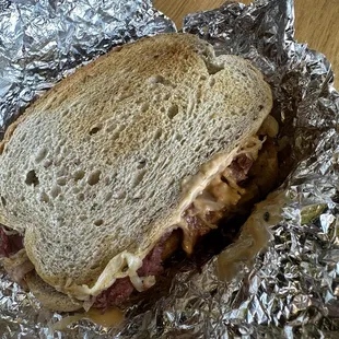 a sandwich wrapped in tin foil