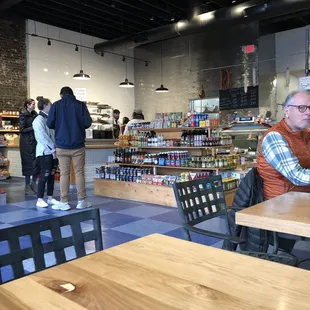Interior. Deli and butcher shop with goods for sale and seating