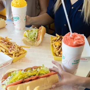 people eating hot dogs and fries