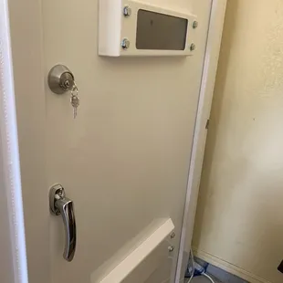 Outside door is thick and well constructed with ventilation on bottom and window above.