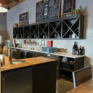 a kitchen with a bar and wine rack