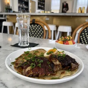 Duck and scallion pancake (front) and melon salad (back)