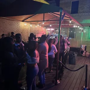 a crowd of people standing outside at night