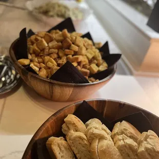 a bowl of bread and a bowl of crackers