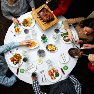 a group of people sitting around a dinner table