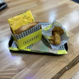 Egg sandwich and hash browns with great sauce