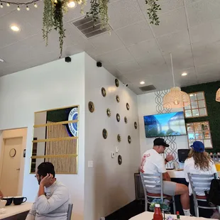 people sitting at tables in a restaurant