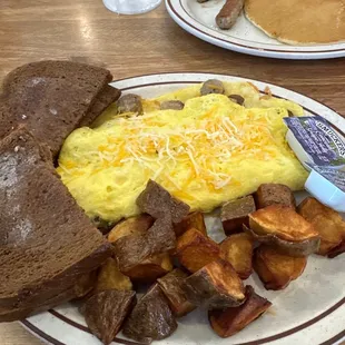Sausage omelette with what appears to be deep fried potatoes , rye toast with a side of small cakes and sausage $30 ???