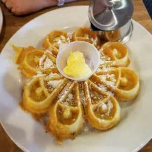 Waffles and butter with side of syrup.