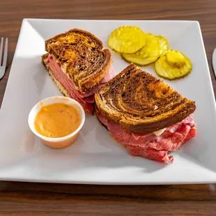 a sandwich and pickles on a plate
