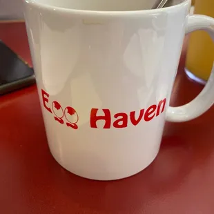 a coffee cup with a spoon in it