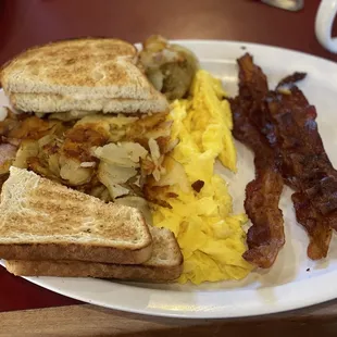 Bacon, eggs, home fries, and white toast