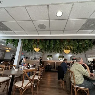 people sitting at tables in a restaurant