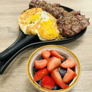 Steak Skillet w/ fried eggs and fruit bowl