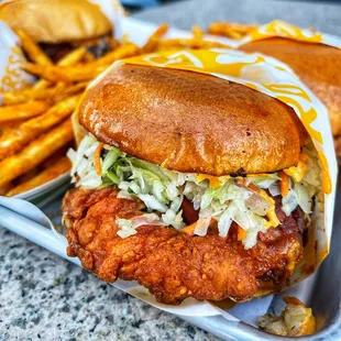 Nashville Hot Sandwich with Choice of Grilled or Fried Chicken, Vinegar Slaw, Pickles and Crack Sauce on a Toasted Brioche Bun.