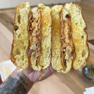 a hand holding a sandwich