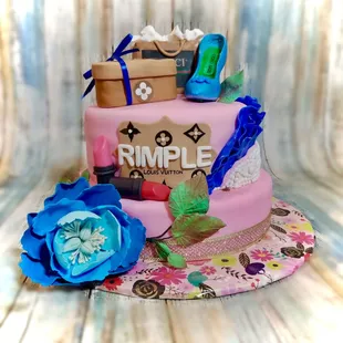 a pink cake with blue flowers