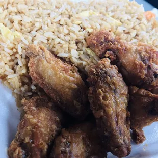 chicken wings and rice in a styrofoam container